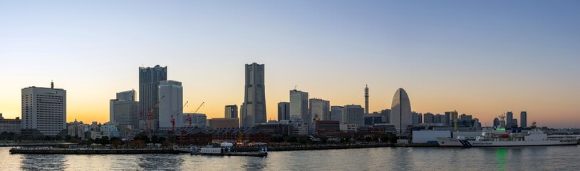 Fototapeta na wymiar Panoramic view of Yokohama Minato Mirai 21 seaside urban area in central Yokohama with Landmark tower at Magic hour.