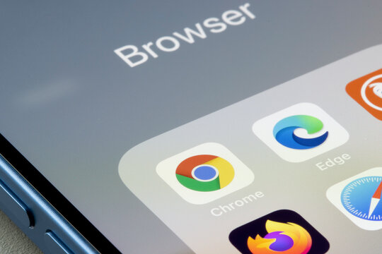 Portland, OR, USA - Dec 13, 2021: Google Chrome app is seen on an iPhone next to Edge and other web browser apps. Microsoft is using new prompts in Edge to try and stop users from downloading Chrome.
