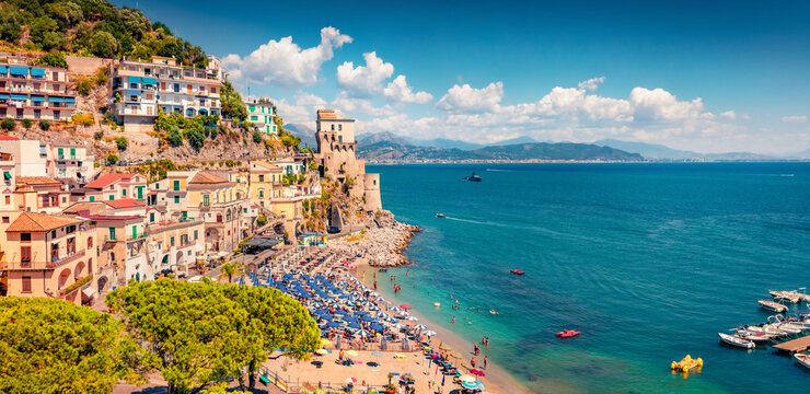 Incredible summer view of historical landmark - Torre di Cetara tower. Spectacular morning cityscape of Cetara town. Wonderful Mediterranean seascape. Vacation concept background.