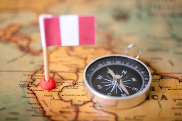 the flag of Peru and the compass on the world map.