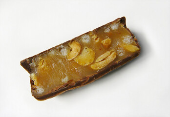Chocolate candy with nuts and caramel filling on white backgroun