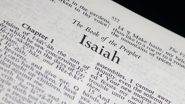Close Up Bible Page Turning to the book of Isaiah