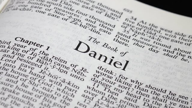 Close up of Bible Page Turning to the book of Daniel