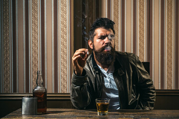 Bearded man with glass of whiskey. Expensive drink. Male drinking brandy or cognac. Degustation,...