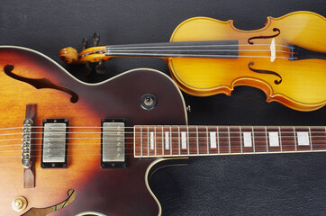 Fototapeta premium Jazz electric guitar and violin on a black background.