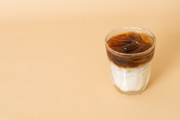 iced coffee with milk layer in glass