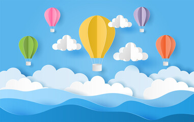 Fototapeta premium Paper cut style of colorful hot air balloons and cloud over the sea with blue sky. Vector illustration