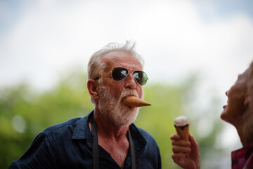 elderly senior couple woman and man having fun and happy together at amusement them park