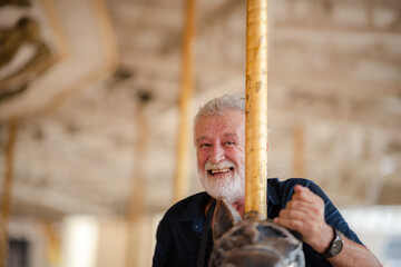 elderly senior couple woman and man having fun and happy together at amusement them park