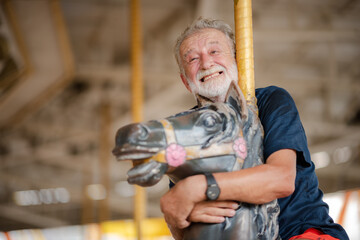 elderly senior couple woman and man having fun and happy together at amusement them park