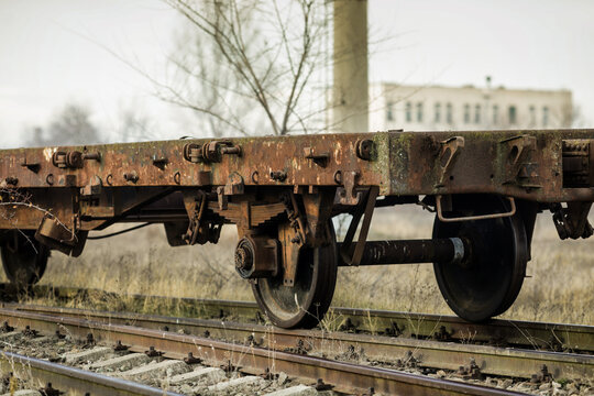 Shallow depth of field (selective focus) image with old and rusty railway industrial transportation waggon (dresine).