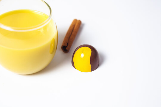 Mexican Colorful chocolate candy bonbons with rompope or eggnog and cinnamon on white background