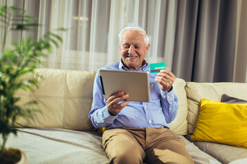 Senior man grandfather shopping online with tablet and credit card at home.