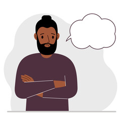 Young sad and upset man thinks and blank thought, speech bubble. The arms are crossed over the chest. Place for your text.
