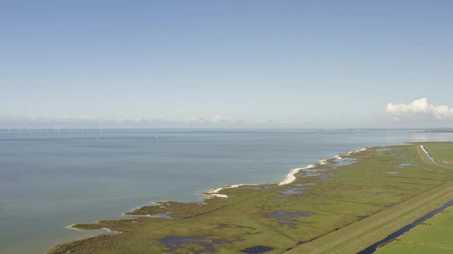 Aerial shot of a natural coastal region in Friesland, the Netherlands, on a beautiful sunny summer day, concept for geology and erosion
