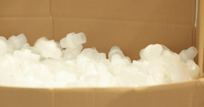 Finished Plastic Products Dropping Into A Carton Box For Packaging. Injection Molding Company. Close Up, Slider Shot