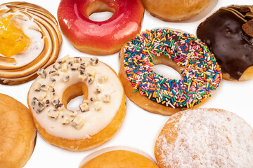 1 dozen mixed donuts, original flavor, chocolate, marmalade and fancy toppings on white background.
