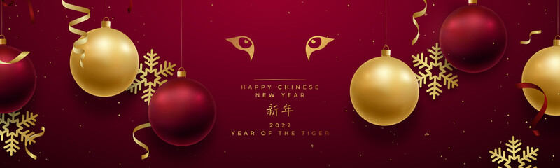 Chinese new year 2022 banner. Tiger Zodiac sign. Golden eyes of tiger on red festive background. Realistic decorative elements hanging on red wall background. Chinese Translation: Happy new year.