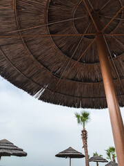 Fototapeta na wymiar Wooden beach umbrellas in the sky