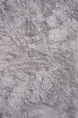 Minimal texture concept. Beautiful faux fur extra soft cover. Gray fur background with creative copy space