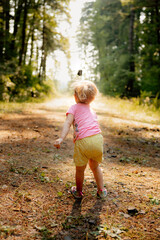 little girl throughing rocks