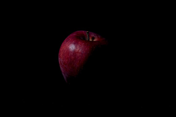 red apple on black background