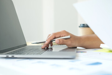 work from home, The hand of a woman who works in finance sits at his desk at home and calculates financial graphs showing the results of his investments, planning the steps of his business growth