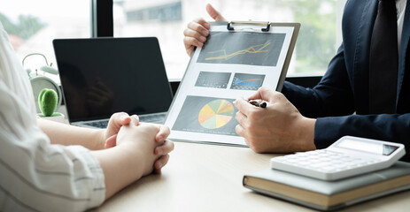 Two business leaders talk about charts, financial graphs showing results are analyzing and calculating planning strategies, business success building processes
