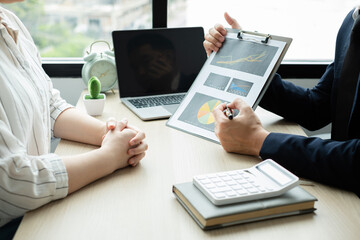 Two business leaders talk about charts, financial graphs showing results are analyzing and calculating planning strategies, business success building processes