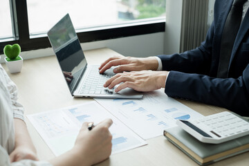 Two business leaders talk about charts, financial graphs showing results are analyzing and calculating planning strategies, business success building processes