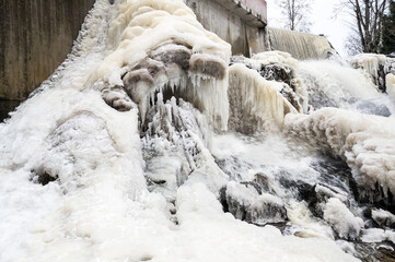 Partly frozen Keila-Joa waterfall in winter