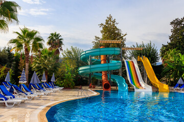 Swimming pool with water slide at the tropic summer resort
