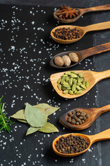 Spices selection over dark wooden table. Food or spicy cooking concept, Healthy eating Background.