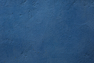 an old iron wall with old paint that has become dull and rusty due to time and weather conditions.  close-up.  can be used as a photo background