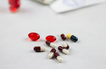 Multicolored pills on white background