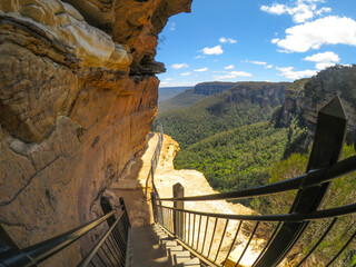 Fototapeta premium Hiking trail along the cliff with beautiful mountain view of Wentworth Falls, New South Wales, Australia.