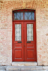 Closed wooden doors on the facade of the building