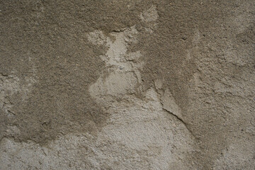 concrete texture close up.  there are small cracks on the concrete surface, which create an interesting texture structure.  transition of shades.  can be used as a photo background