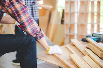 young carpenter Asian man, wooden maker craftsman working with a industry carpentry tool workshop