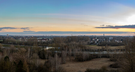 Fototapeta premium View from the Müllberg over the city of Augsburg towards the Alps in the evening at sunset