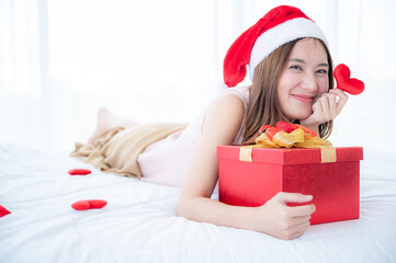 Christmas gift box concept, young Asian woman are happy and smile with a surprise gift present