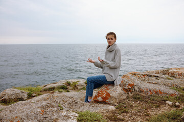 Naklejka na ściany i meble woman nature rocks coast landscape Ocean Lifestyle