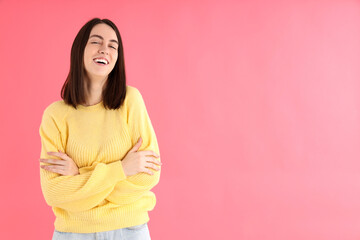Obraz premium Attractive girl in yellow sweater on pink background