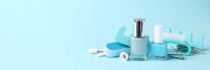 Concept of nail care with manicure accessories on blue background