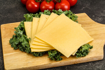 Sliced Gauda cheese over board