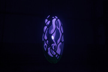 Purple abstract object in dark. Trendy color 2022.