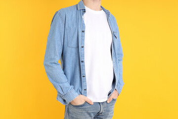 Man in blank t-shirt and in shirt on yellow background