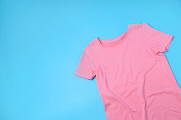 Blank pink t-shirt with space for print on blue background