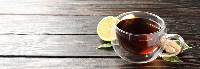 Concept of hot drink with tea on dark wooden background