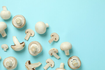Flat lay composition with champignons on blue background